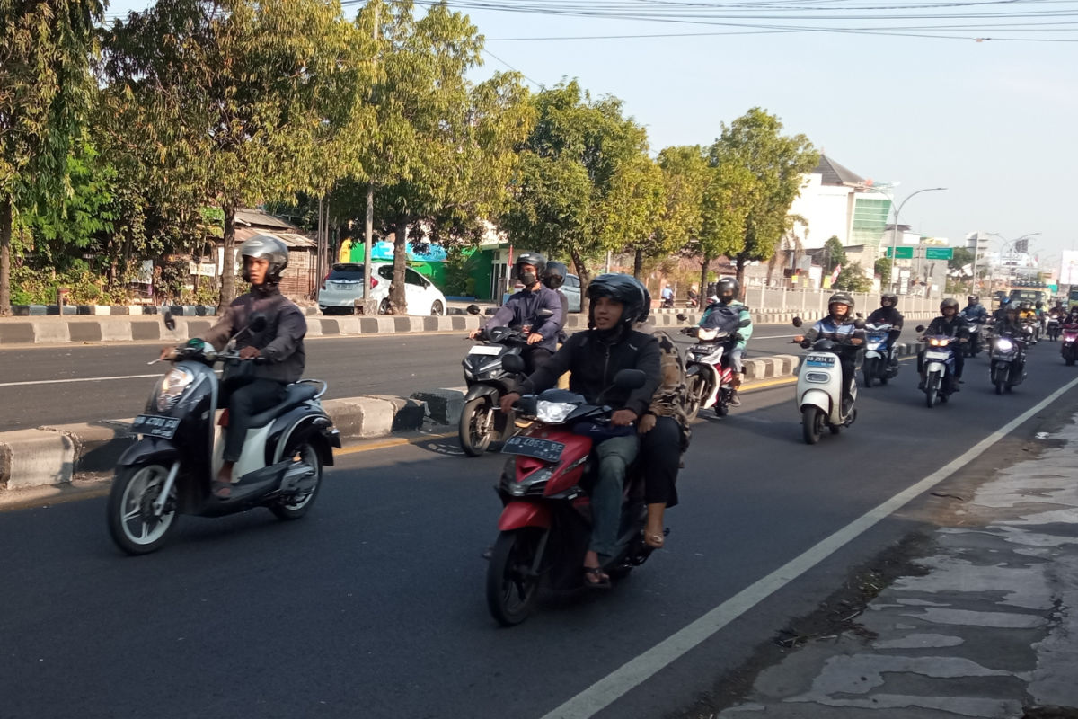 Moped Drivers On Main Road in Daytime.jpg