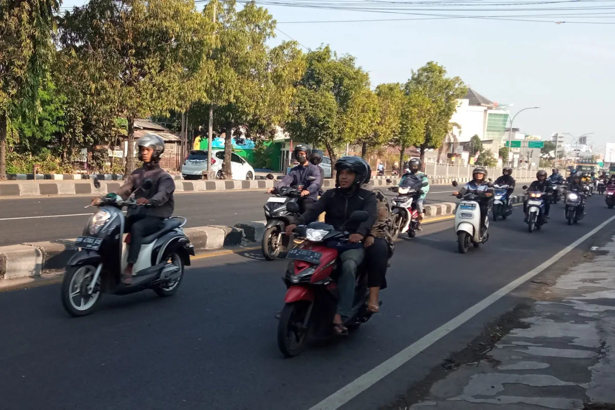 Moped Drivers On Main Road in Daytime.jpg