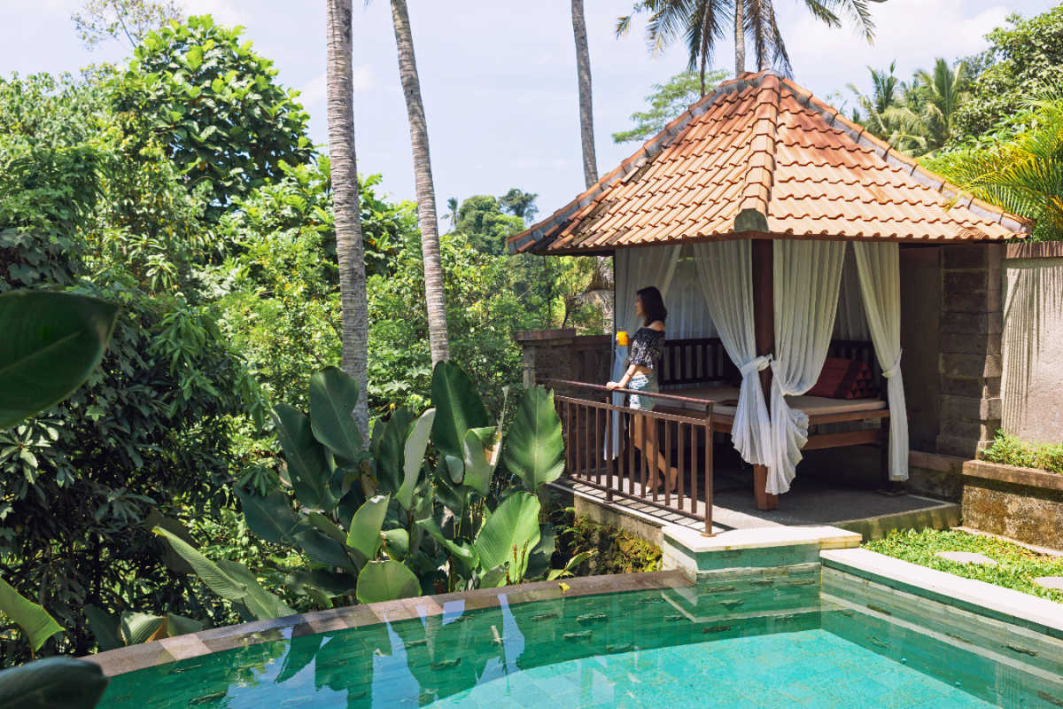 Woman Stands At Pool Shala in Bali Villa.jpg