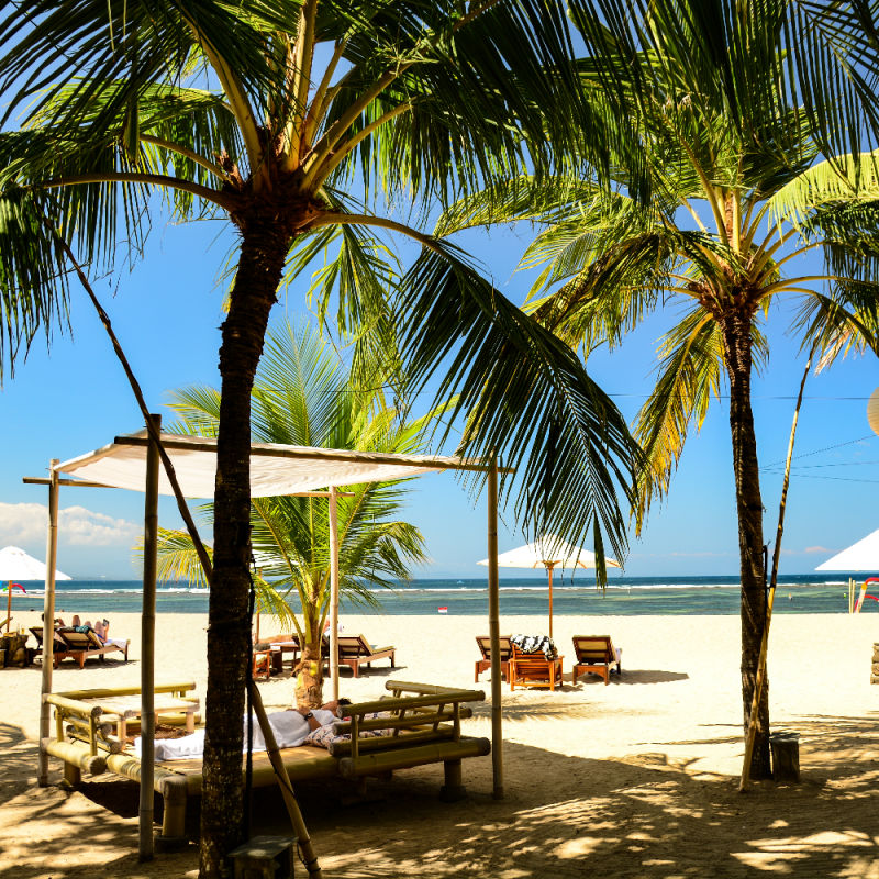 Beach-Cabanas-on-Sanur-Beach-Under-Palm-Tree