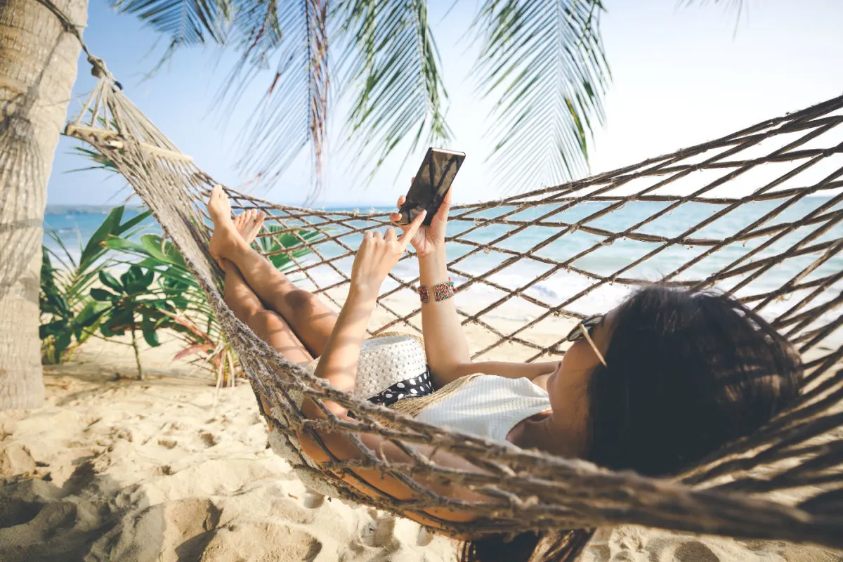 Woman in Hammock on Beach with Phone.jpg