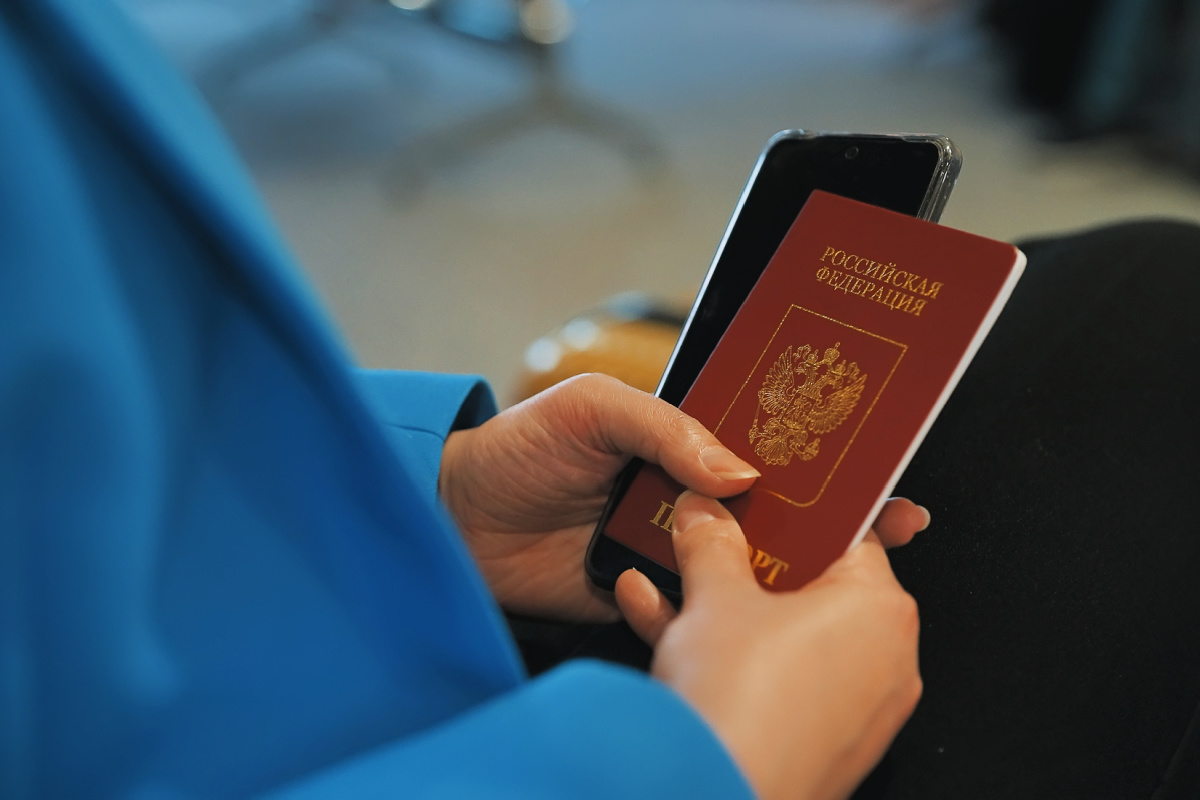 Womans hand holds Russian Passport.jpg