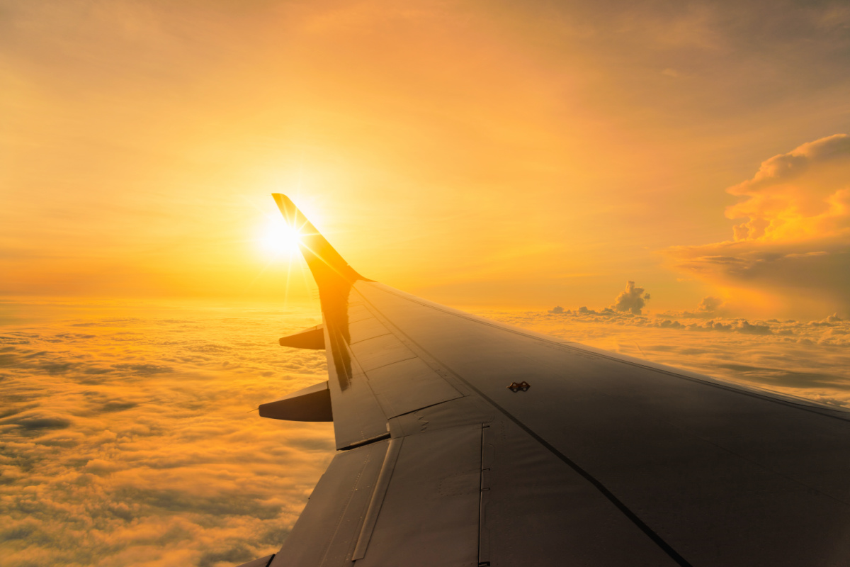 Plane Wing In Sky At Sunset.jpg