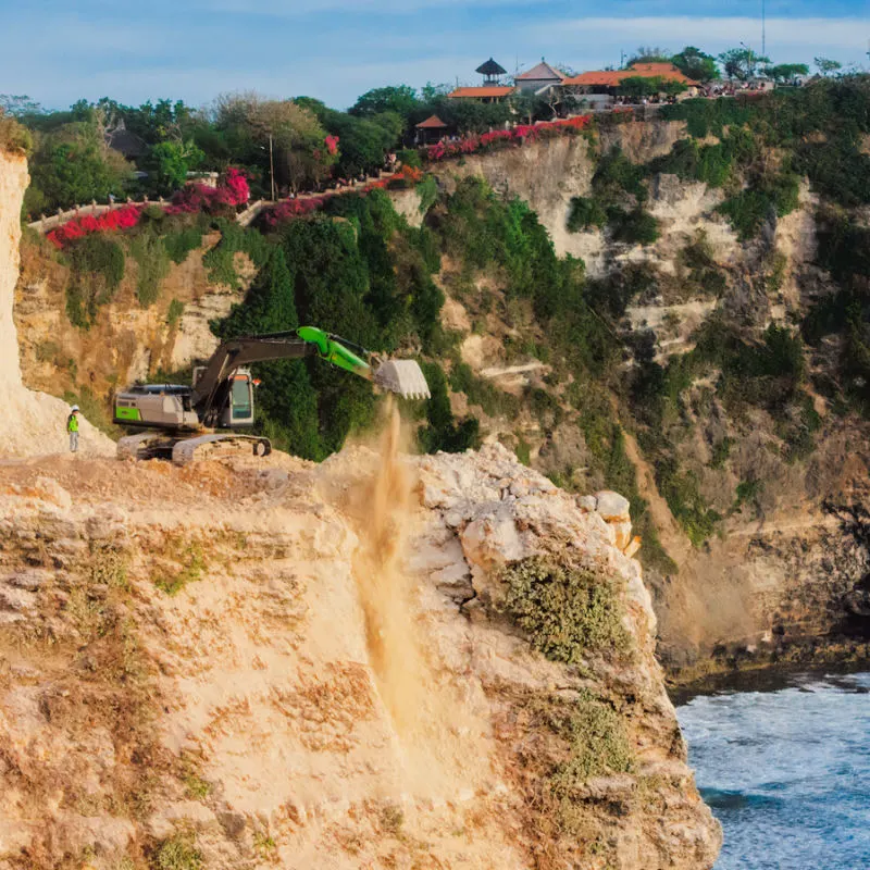Digger and Heavy Machinery Work On Uluwatu Cliff in Bali.jpg