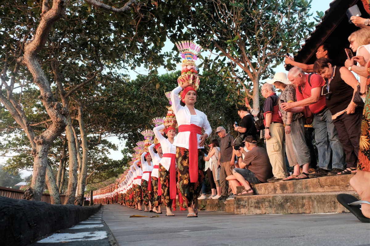 Balinese Women In Cultural Parade While Bali Tourists Watch.jpg