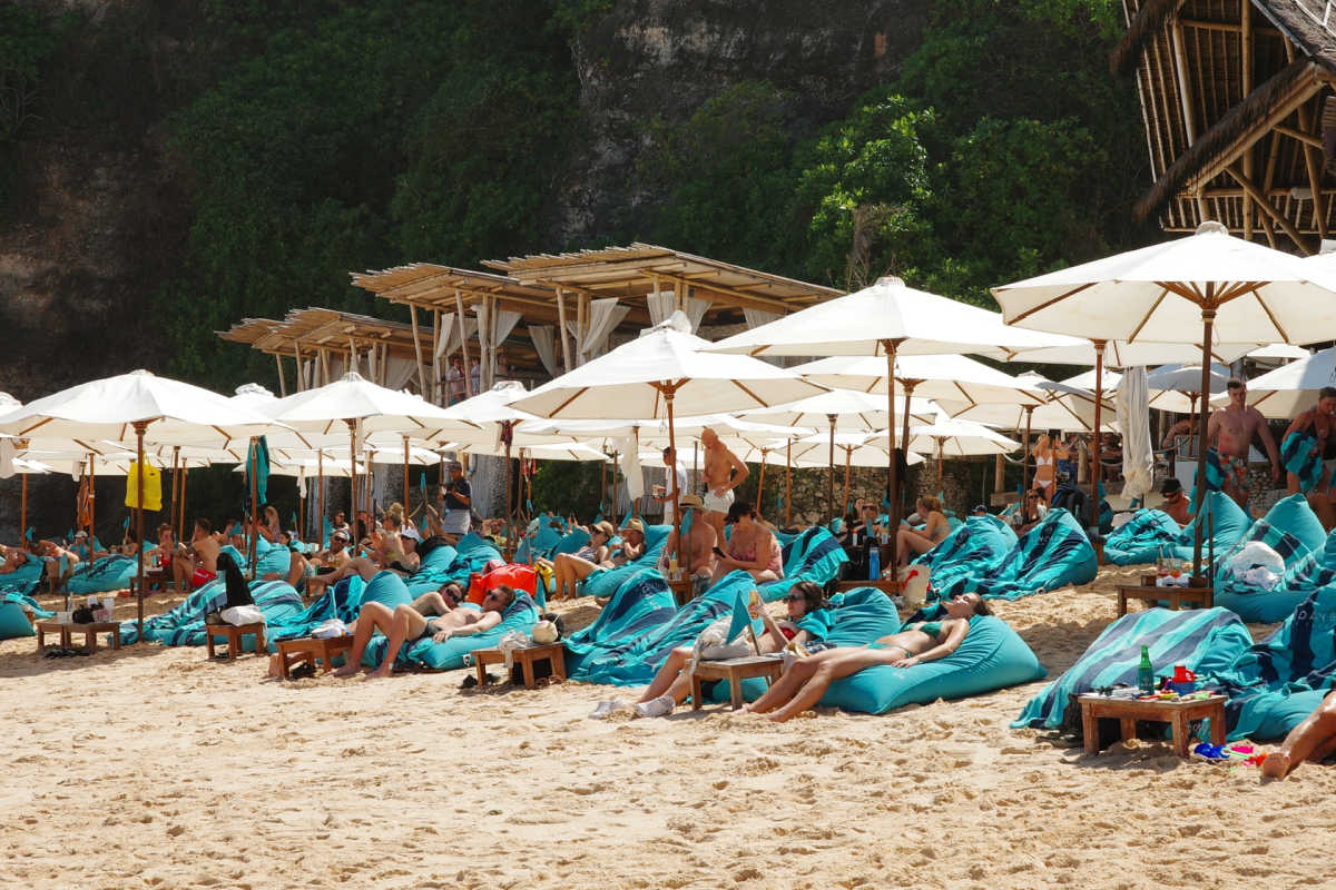 Tourists Sunbathe on Beanbags on Sunday's Beach Club in Uluwatu Bali.jpg