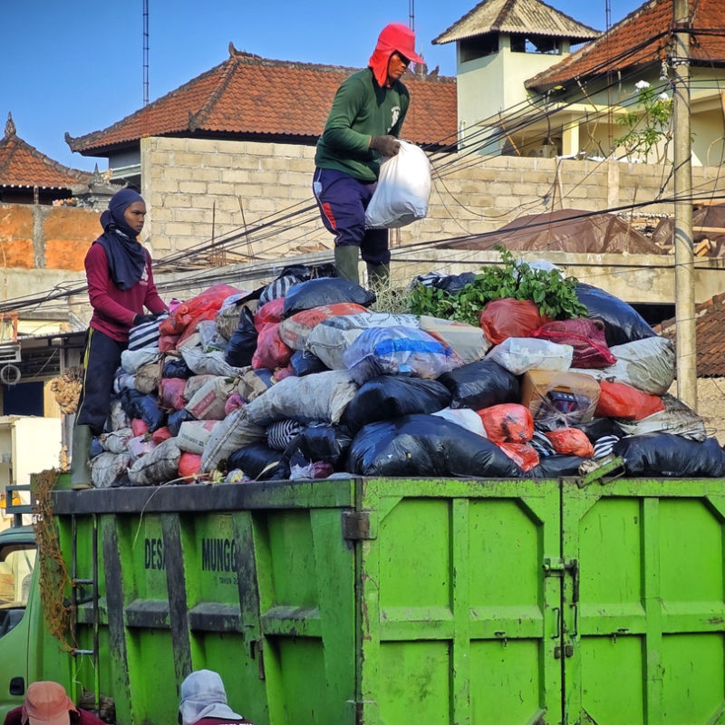 Trash-Collectors-on-Waste-Garbage-Truck-in-Bali