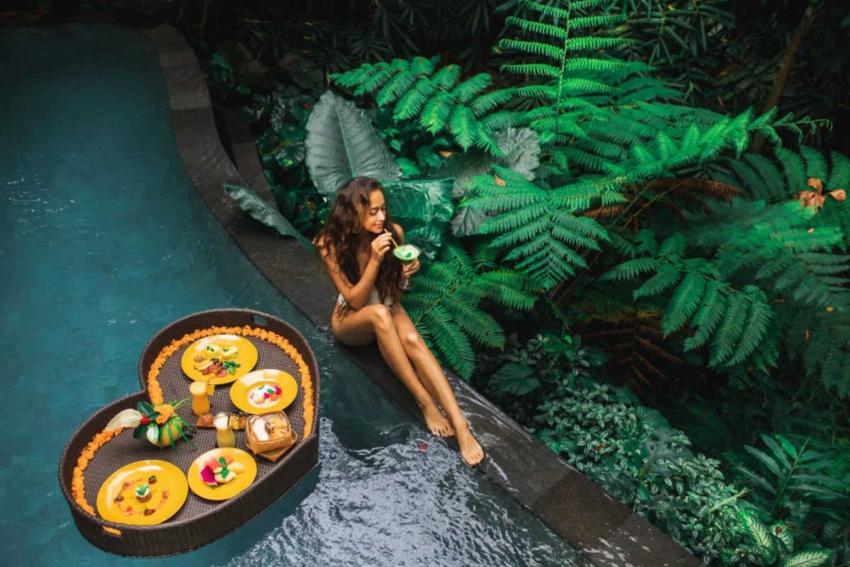 Woman enjoys floating breakfast in Bali