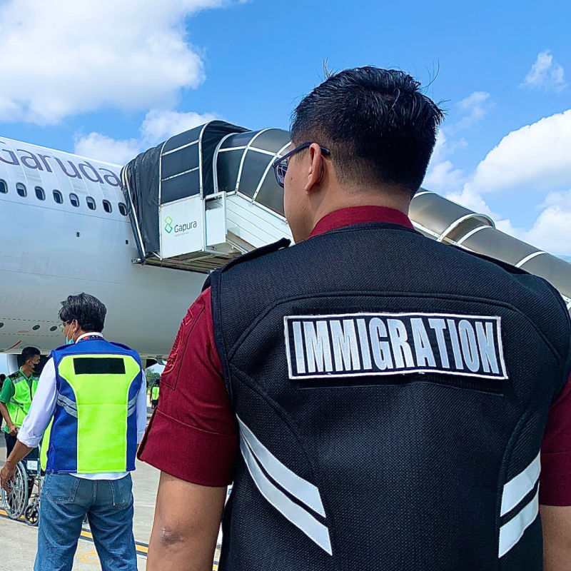 Immigration-Officer-Looks-at-Plane