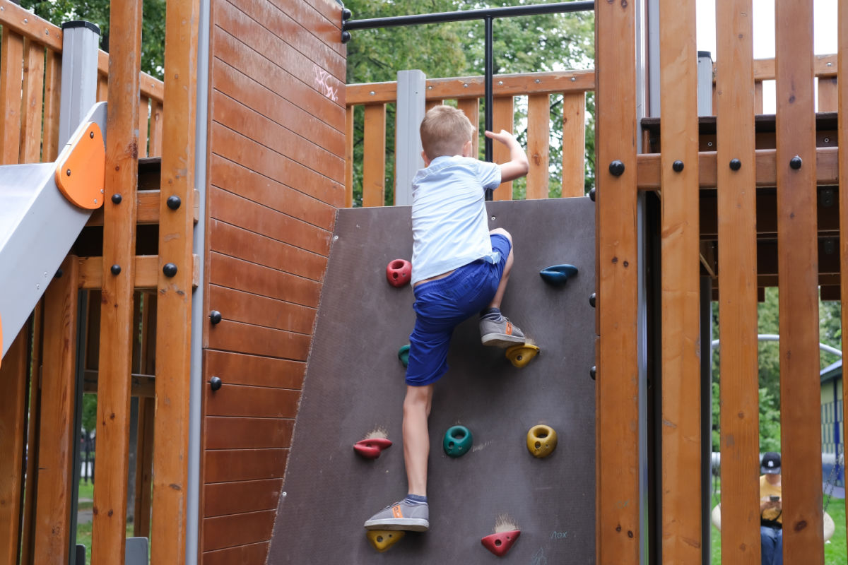 Child Climbs On Outdoor Playground.jpg