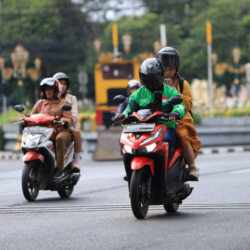 Two-Mopeds-Drive-On-Main-Road