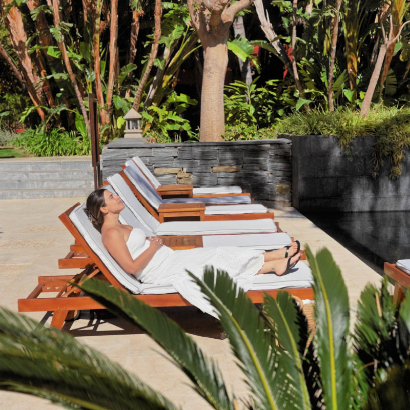 Woman-Sits-On-Sun-Lounger-By-Pool-Wellness-Bali