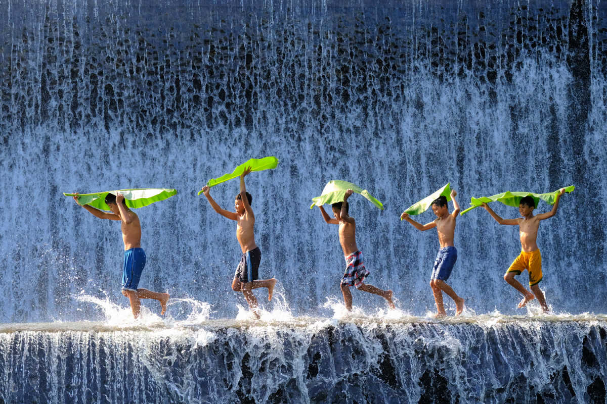 Kids play at Bali's Tukad Yeh Unda Dam