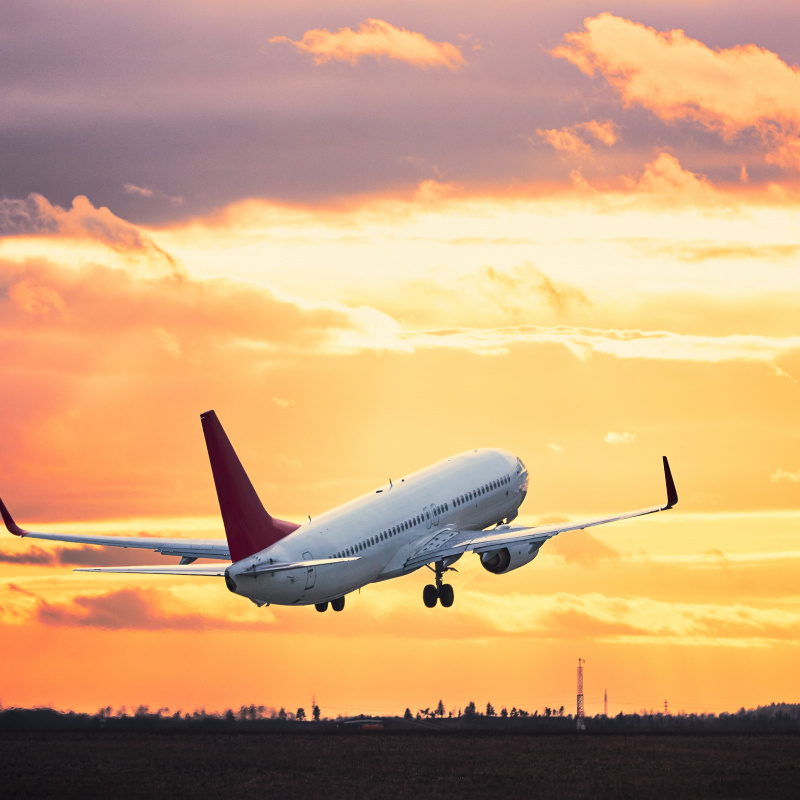 Airplane-Takes-Off-At-Sunset-from-Airport