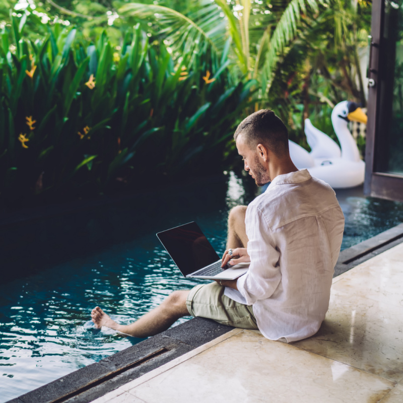 Digital-Nomad-Works-on-Laptop-By-Villa-Pool-in-Bali