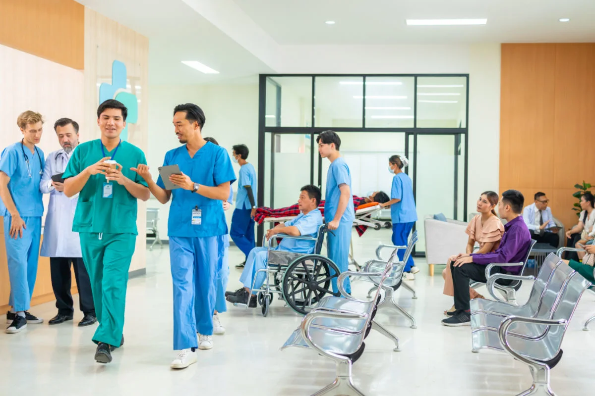 Doctors In Modern Hospital Reception Area.jpg
