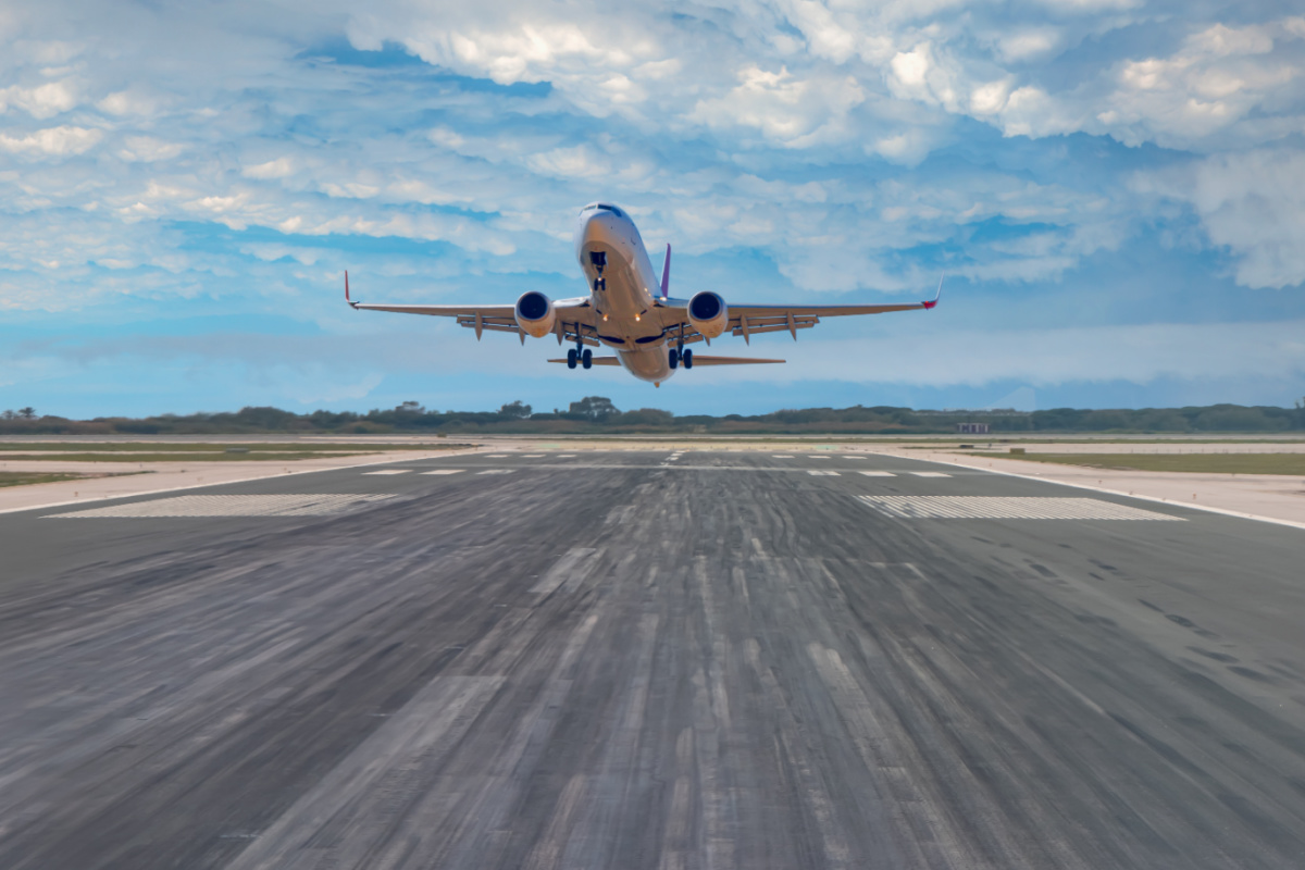 Plane Takes Off From Airport Runway.jpg