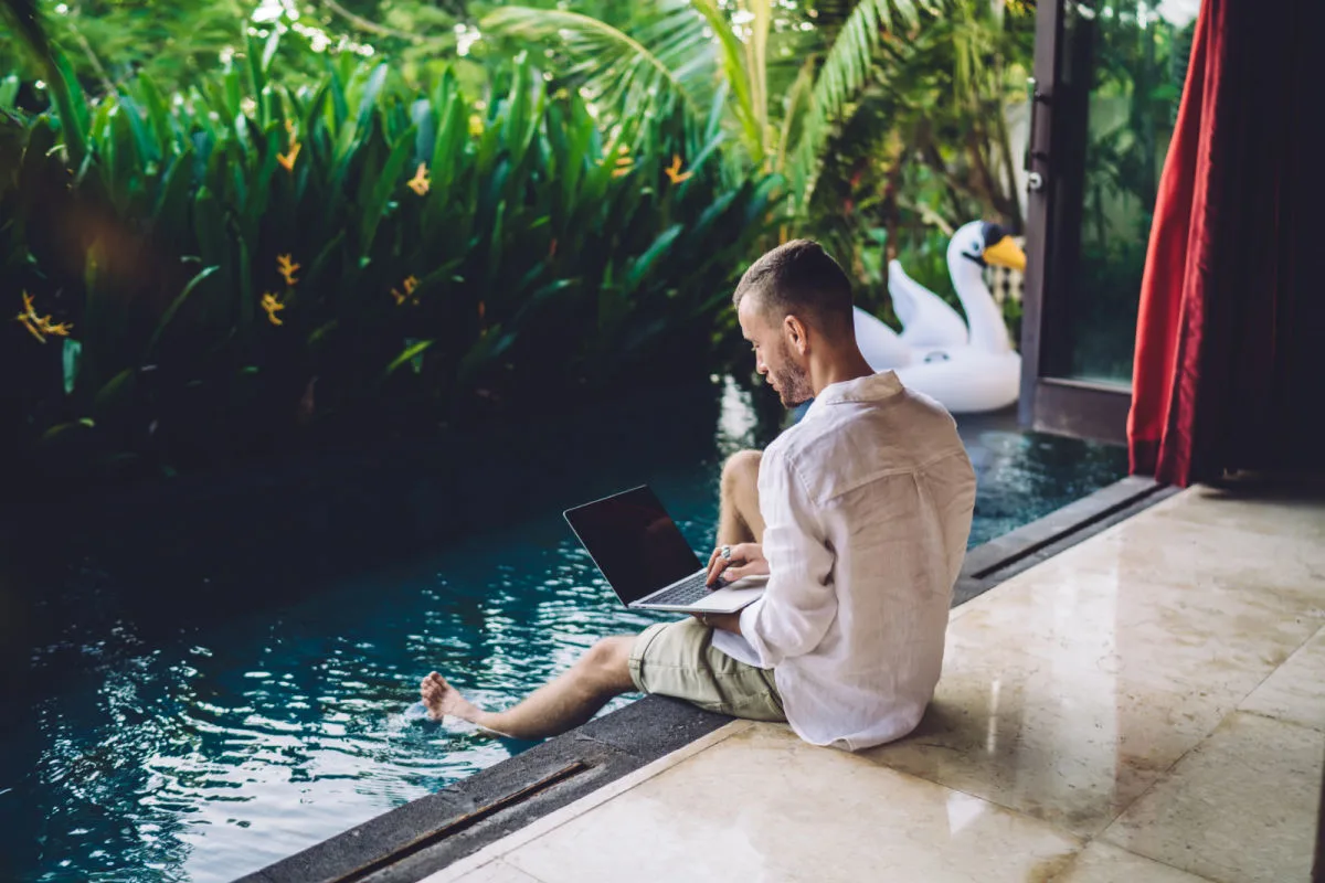 Digital Nomad Works on Laptop By Villa Pool in Bali.jpg