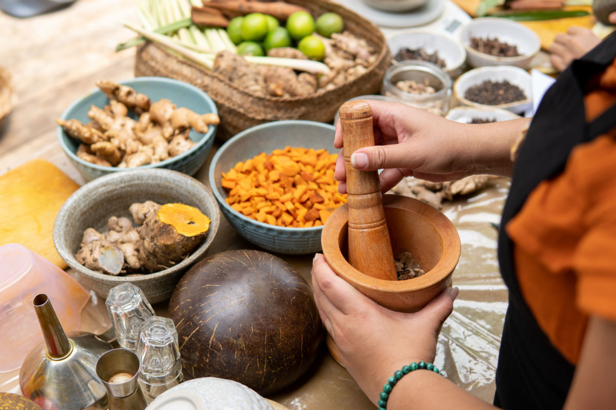 Woman Makes Jamu Wellness Drink in Bali.jpg