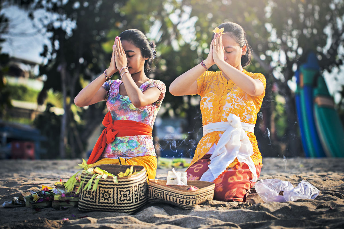 Two Balinese Women Pray On Bali Beach.jpg