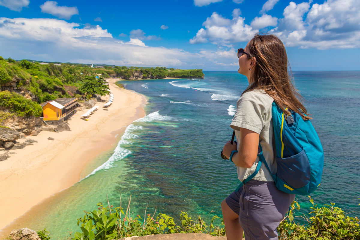 Woman Backpacker Tourists Looks Over Dreamland Beach Bali.jpg