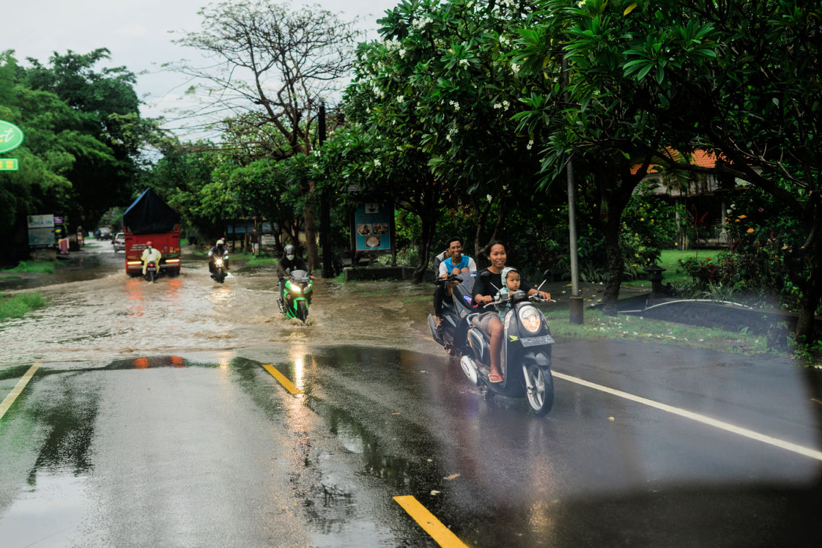 Drivers Drive Moped In Rain Storm Flood Bali.jpg