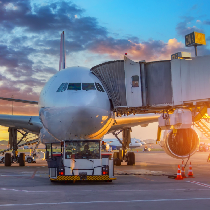 Plane With Boarding Tunnel At Airport.jpg