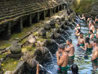 Tourists Take Part In Balinese Water Purification Ceremonies Ready For A New Year