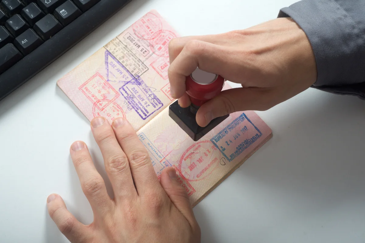 Immigration Officer Stamps Visa Passport.jpg