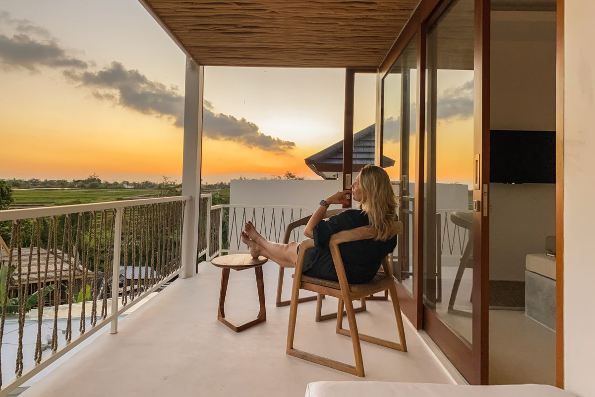 Woman Sits On Balcony of Bali Hotel.jpg