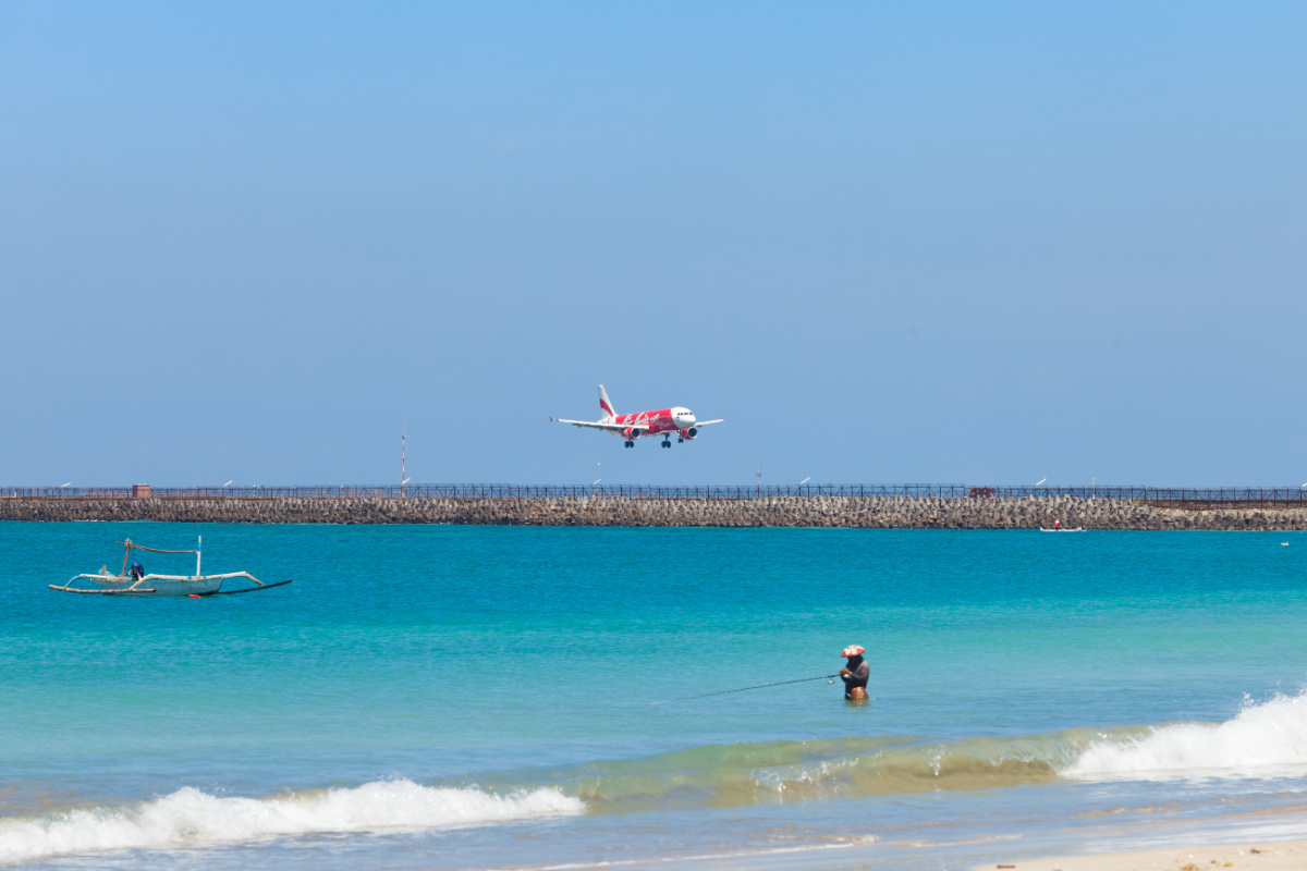 
Plane Comes Into Land At Bali Airport Over Ocean