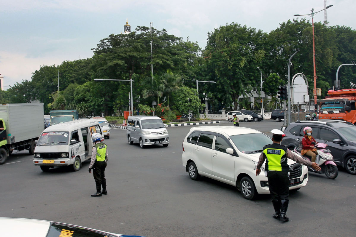 Traffic Police Officers Direct Traffic On Road In Bali.jpg