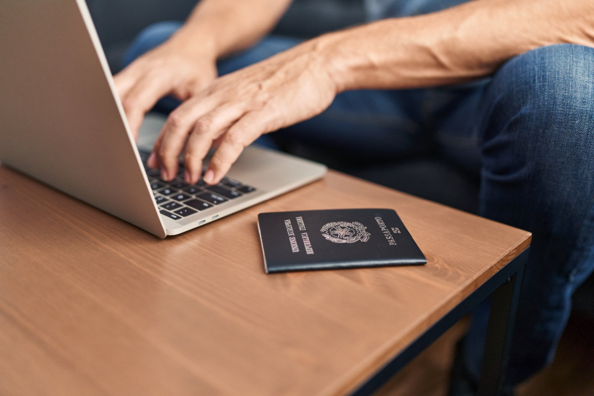 Laptop Passport Hands Close Up.jpg