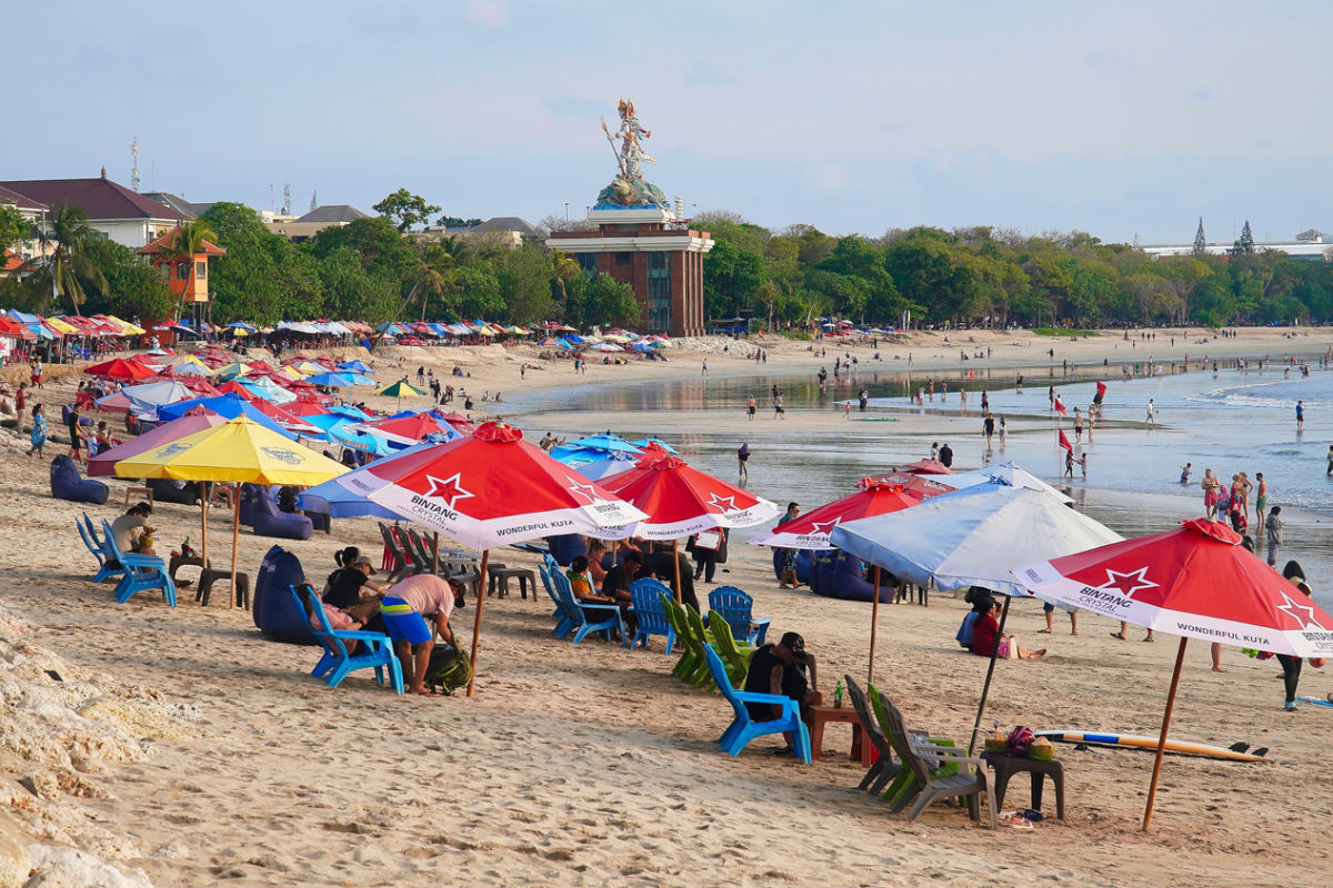 Tourists Relax on Kuta Beach in Bali
