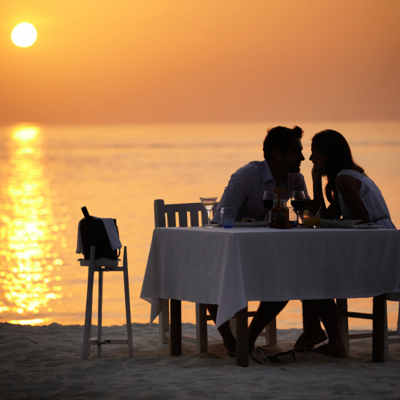 Couple-Have-Romantic-Dinner-On-Bali-Beach-Sunset