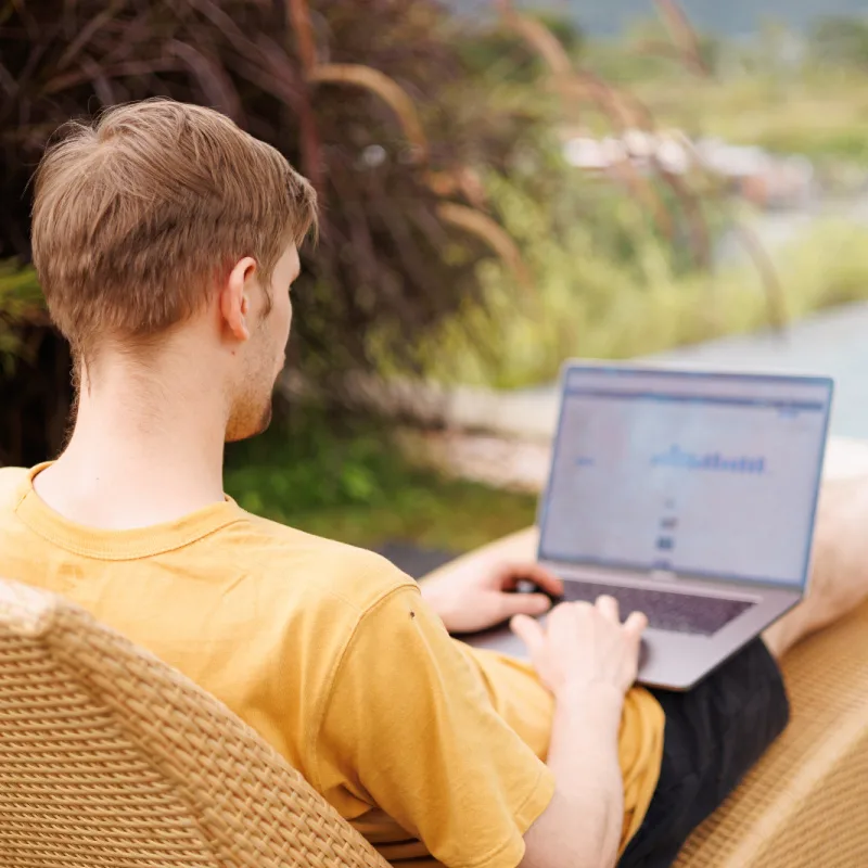 Digital Nomad Works on Laptop