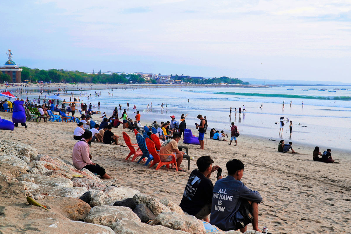 Tourists and Locals Sit on Kuta Beach in Bali.jpg