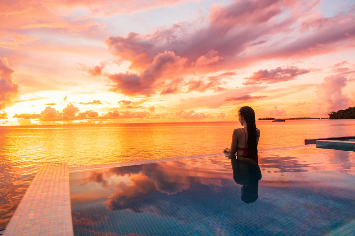 Woman in Ocean Facing Infinity Pool at Sunset.jpg