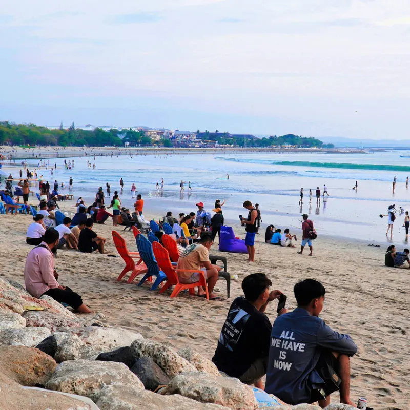 Tourists and Locals Sit on Kuta Beach in Bali.jpg