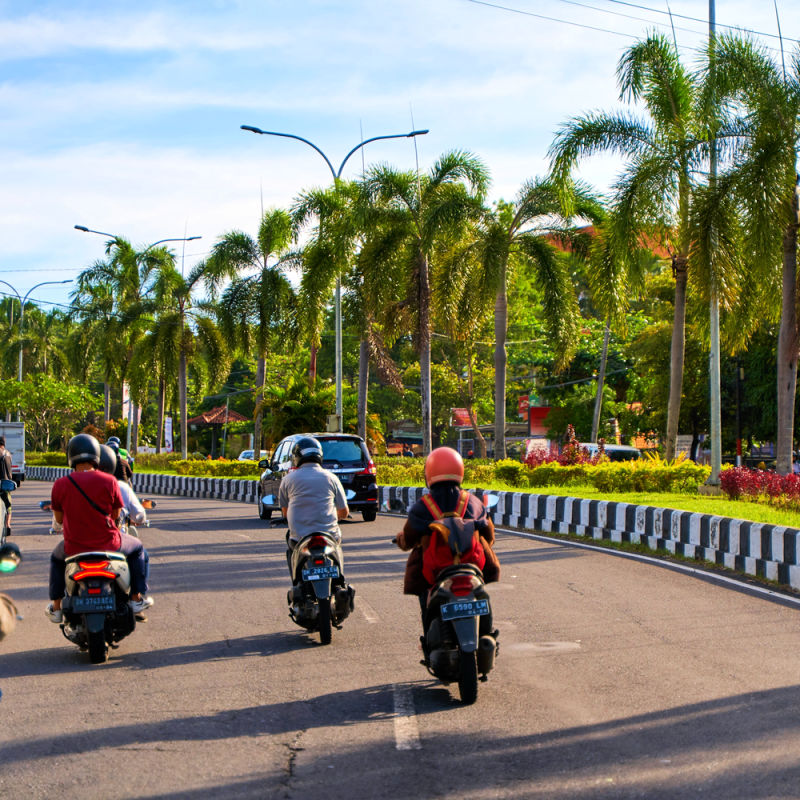 Moped Drivers On Highway in Bali
