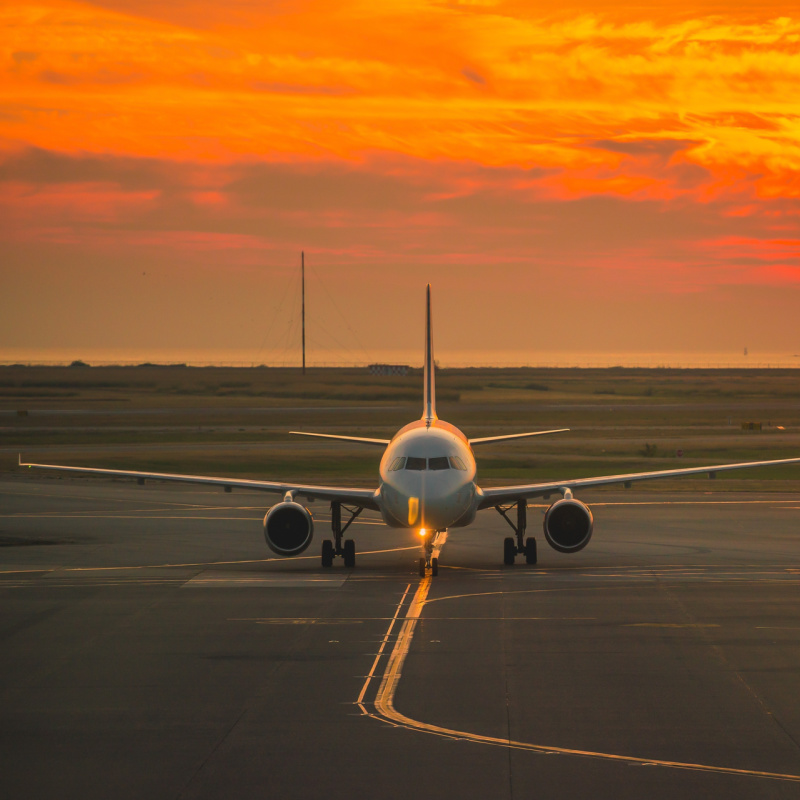 Plane on Airport Runway at Sunset