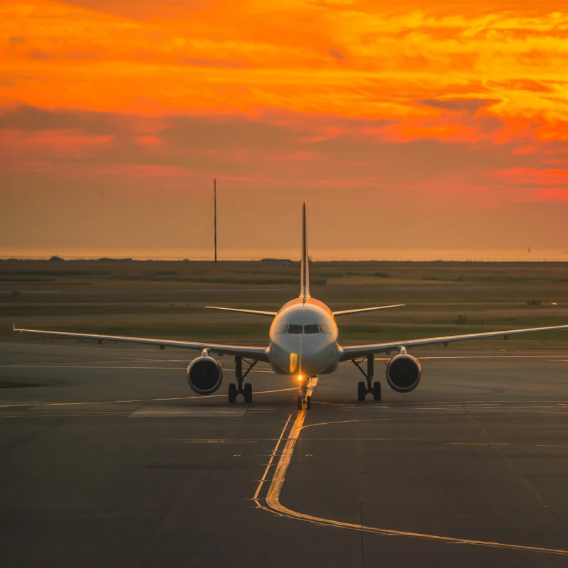 Plane on Airport Runway at Sunset