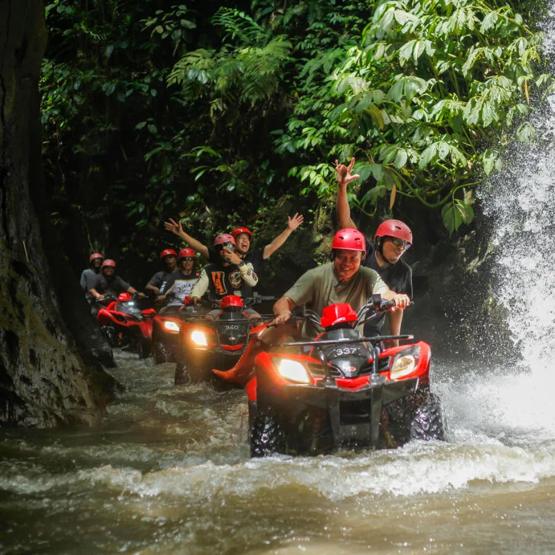 Tourists in Bali Drive ATV in River Jungle Ubud