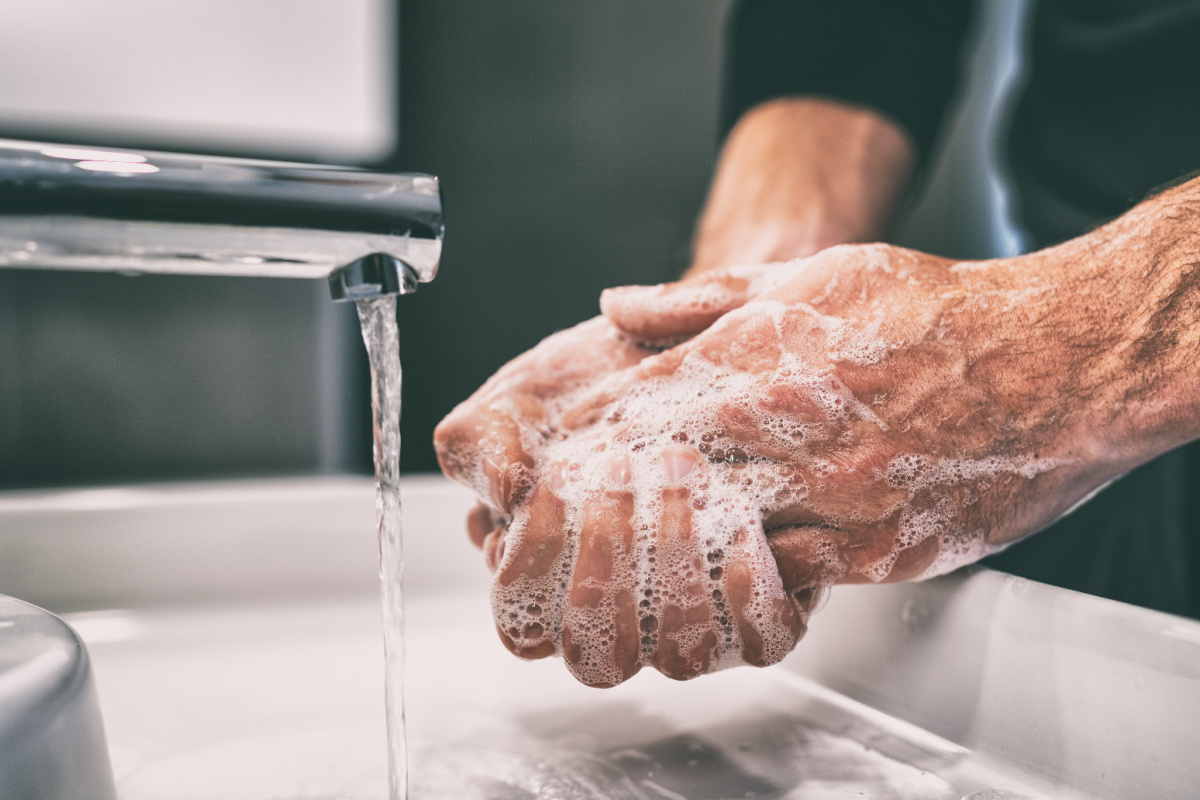 Man Washes Hands Under Sink Tap Water in Bali.jpg