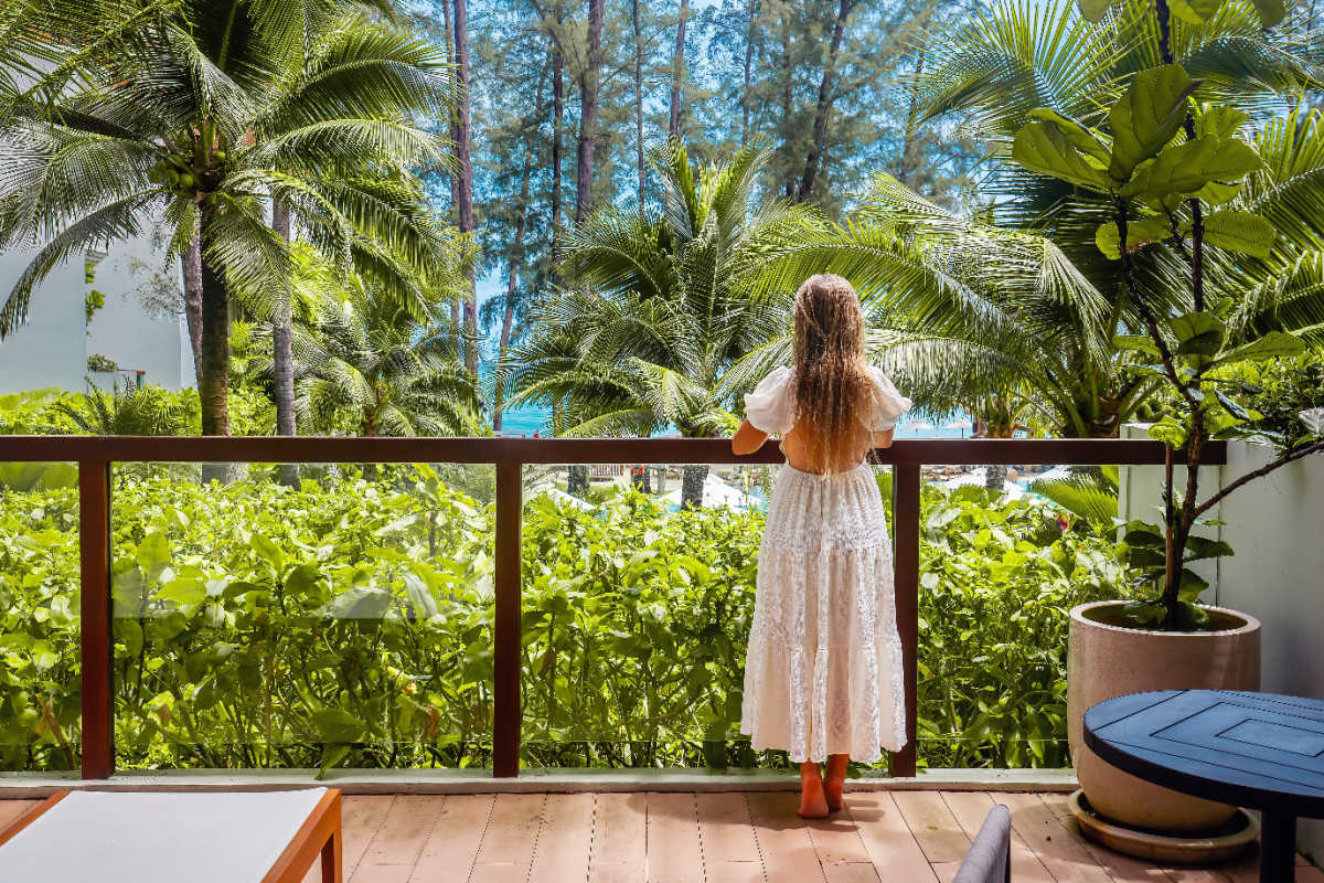Woman Stands on Hotel Balcony in Bali