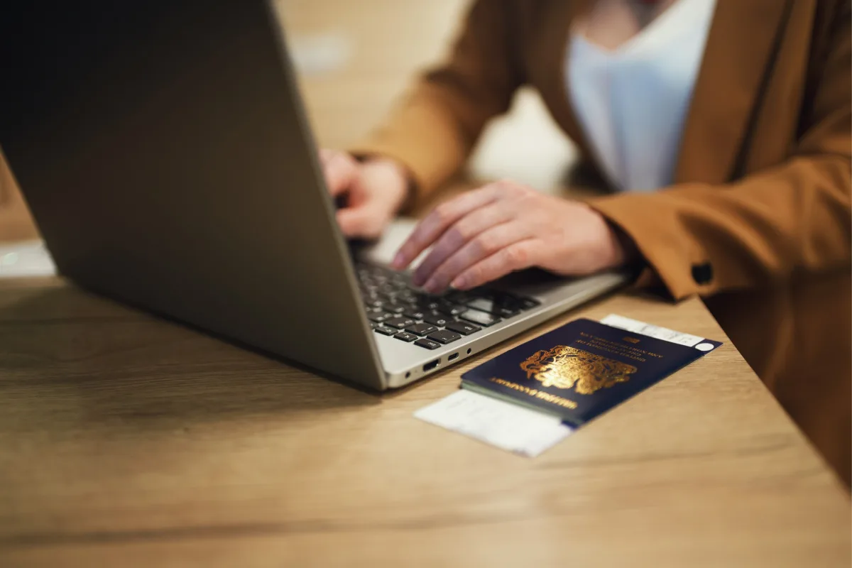 Passport Laptop Tourist At Table.jpg