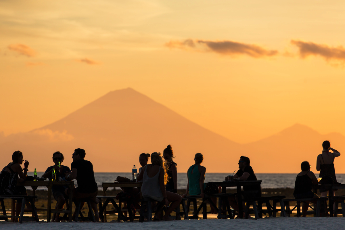 Tourists on Bali Beach Close to Mountain Silhouette.jpg