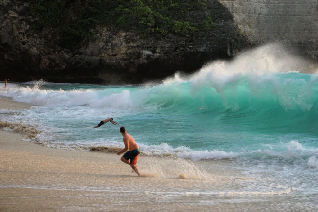Tourists In Ocean At Kelingking Beach in Bali