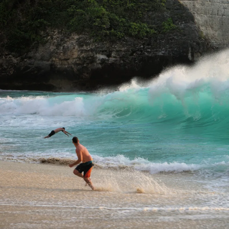 Tourists In Ocean At Kelingking Beach in Bali