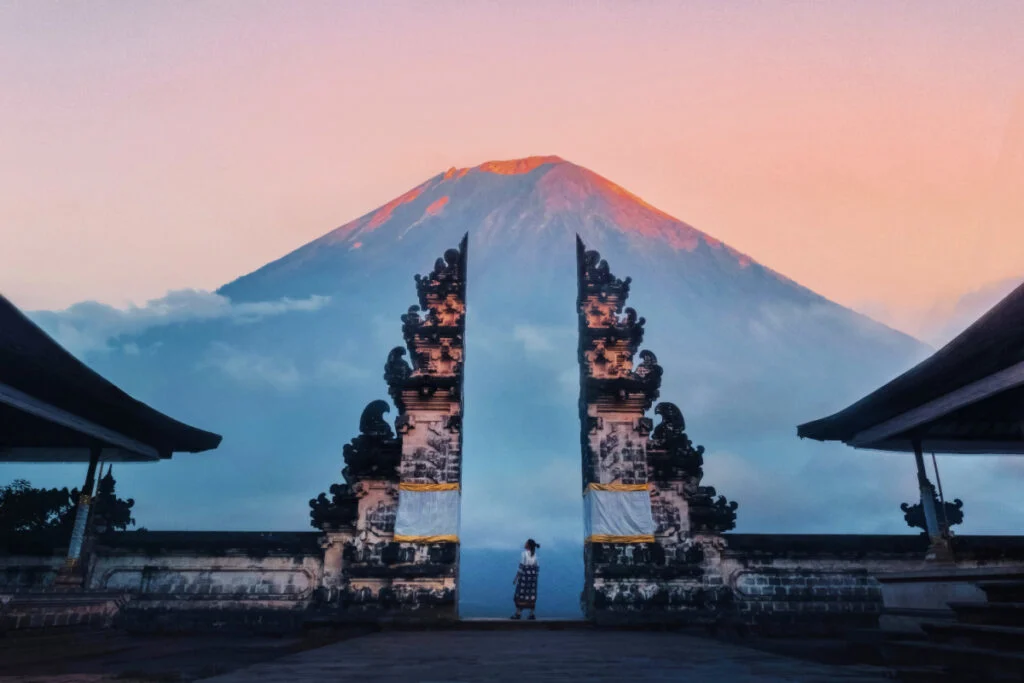Woman Stands At Gates at Pura Luhur Lempuyang Temple, at the Gates of Heaven Temple in Bali